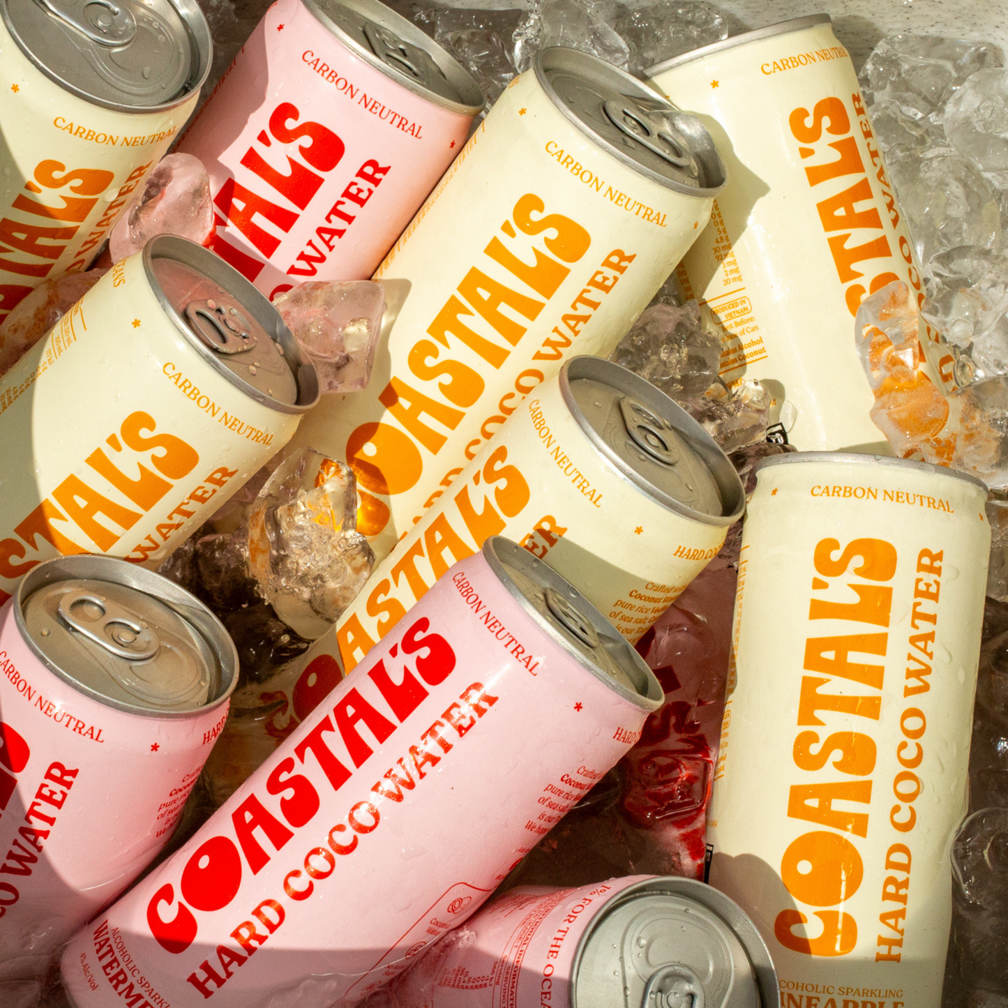 Multiple cans of Coastals Hard Coconut Water in Pineapple and Watermelon on ice